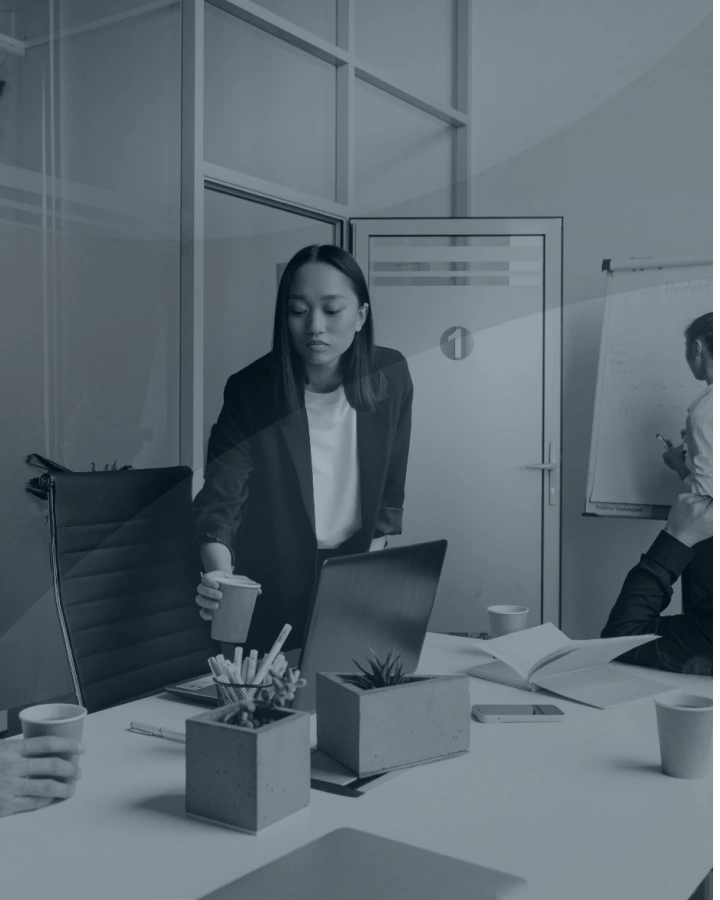 Professional woman working at desk with laptop in modern office