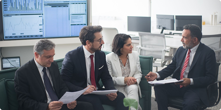Investment teams reviewing portfolio performance and market insights